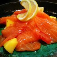 Salmon Ceviche · Fresh salmon sashimi marinated with citrus juice and olive oil on the top of bed of diced ve...