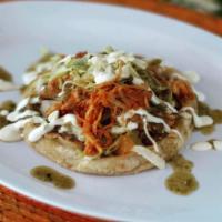 Sope · White corn tortilla topped with beans, cheese, onions and your choice of red or green sauce....