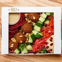 Mediterranean Mezze Salad · A colorful salad loaded with falafel, hummus, sesame seeds, cucumber and pickled cabbage & c...