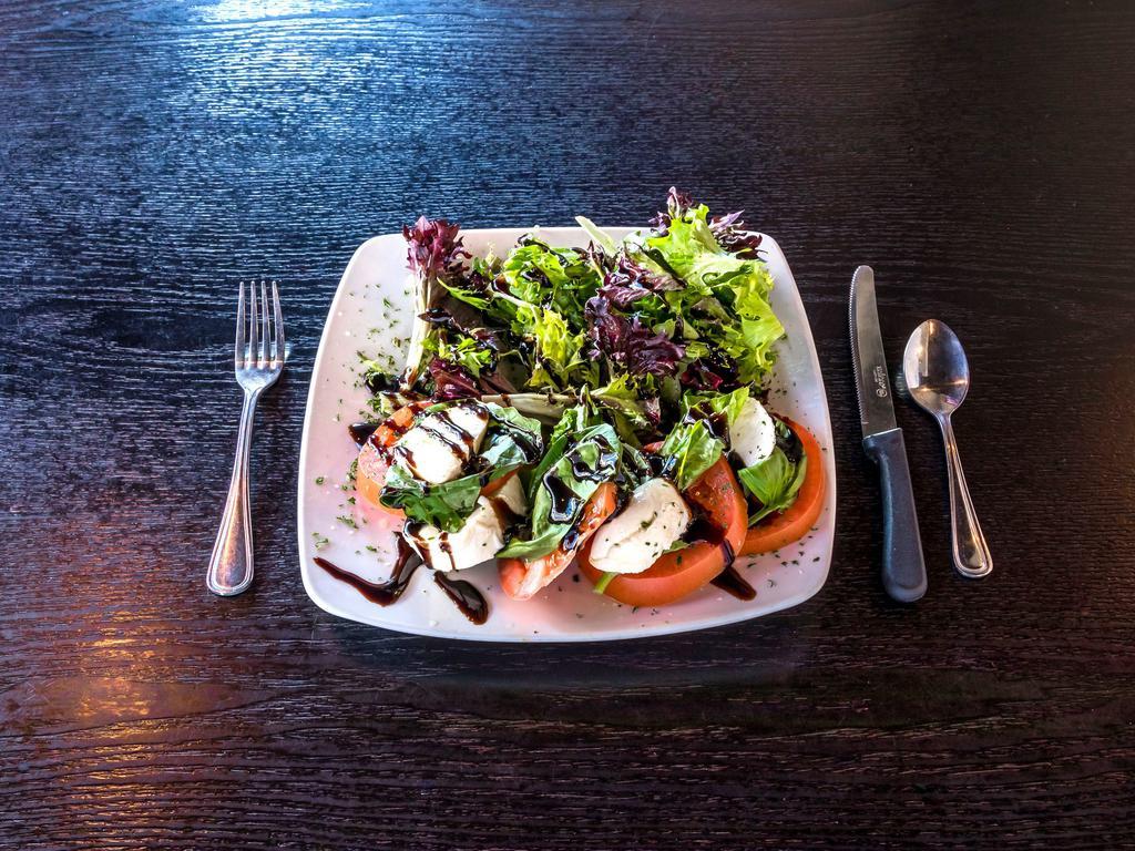 Caprese Salad · Fresh mozzarella cheese, tomatoes, basil, mixed greens, balsamic reduction and olive oil. Add chicken or salmon for an additional charge.
