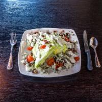 Tru Wedge Salad · 2 crisp wedges of iceberg drizzled with our homemade blue cheese dressing and topped with bl...