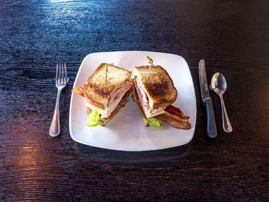 Club House Sandwich · Smoked turkey breast, black forest ham, applewood bacon, iceberg lettuce, tomatoes, Swiss cheese, herb mayo on your choice of whole wheat or sourdough bread.
