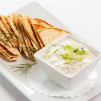 Tzatziki + Pita · fresh Greek yogurt, dill, grated cucumber, lemon + garlic dip served with warm pita wedges