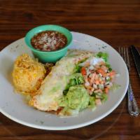 Senor Patron Burrito · Steak, chicken and shrimp burrito topped with cheese and salsa ranchera. Served with rice, b...