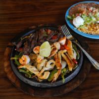 Texas Fajitas · Grilled steak, chicken or shrimp served on a sizzling skillet with onions and bell peppers.
