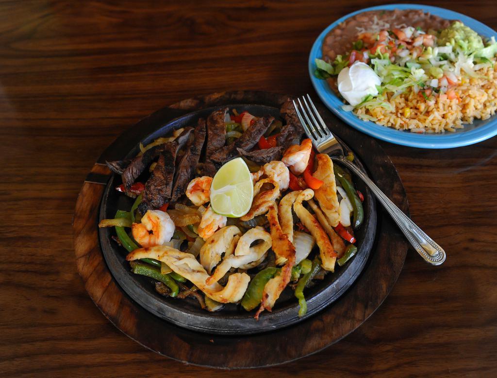 Texas Fajitas · Grilled steak, chicken or shrimp served on a sizzling skillet with onions and bell peppers.