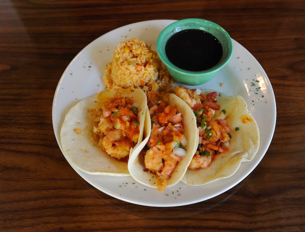Acapulco Tacos · 3 breaded shrimp tacos topped with our house made mango sauce, spicy arbol sauce, pico de gallo and grilled pineapple. Served with rice and black beans.