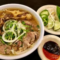 9. Oxtail Pho · steak and oxtail (steak will be delivered raw, please cook in hot pho broth) 
Served with Ri...