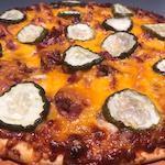 KC Kitchen Pizza · BBQ sauce, pulled pork, cheddar, pickles, and onions.
