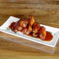 Chicken Wings · 8 pieces. Chipotle Buffalo, guajillo tamarind, white BBQ, and southwestern fire.