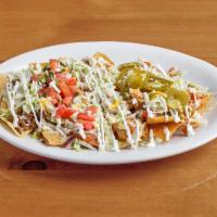 Nachos Supreme · Ground beef ,shredded chicken and beans on a bed of chips covered with lettuce, sour cream, ...