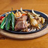 Toro Loco Fajitas · Our main dish with just everything, steak, chicken, shrimp, carnitas, pork rib, chorizo, bac...