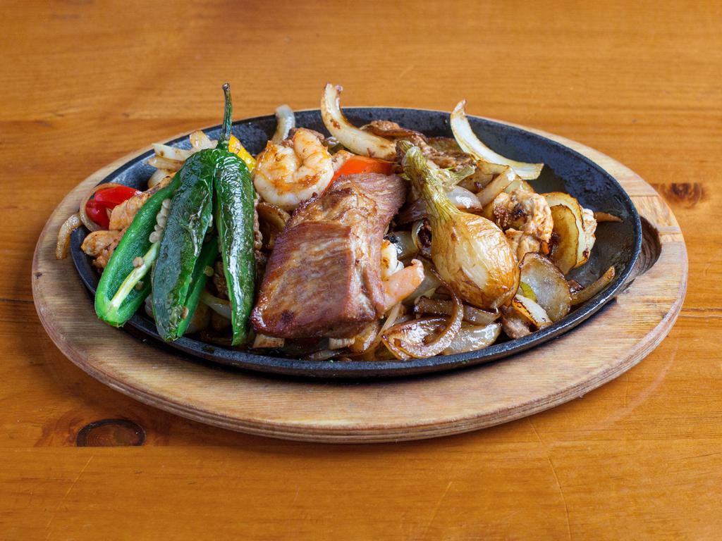 Toro Loco Fajitas · Our main dish with just everything, steak, chicken, shrimp, carnitas, pork rib, chorizo, bacon, a grilled jalapeno pepper and Knob onion.