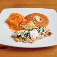 Pollo con Crema · Strips of grilled chicken sauteed with spinach and covered with cheese sauce served with ric...