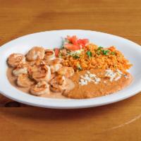 Camarones al Chipotle · Grilled shrimp sauteed with chipotle cream sauce served with rice and choice of beans.