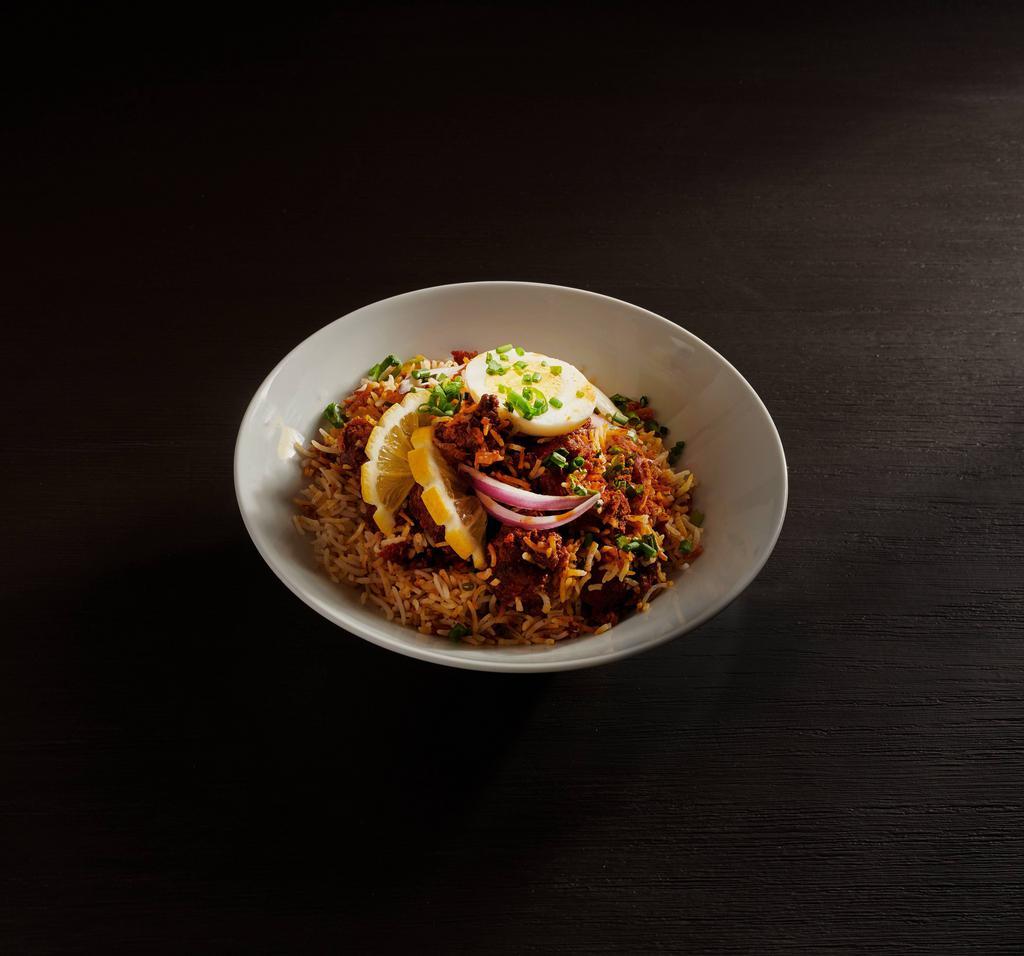 Boneless Chicken Biryani · Flavored with exotic spices and cooked with basmati rice. Served with raitha and gravy.