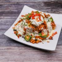 Waffle Fry Nachos · Smothered with white cheddar sauce and shredded cheeses, topped with house smoked chicken an...