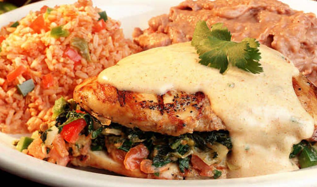 Spinach Stuffed Chicken Breast · A split chicken breast stuffed with our special spinach recipe, pico de gallo and chile con queso, topped with cilantro cream sauce mixed cheeses. Served with rice.