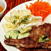 13. Pork Chop XChop · 3 pork chops with rice and pickled veggies.
