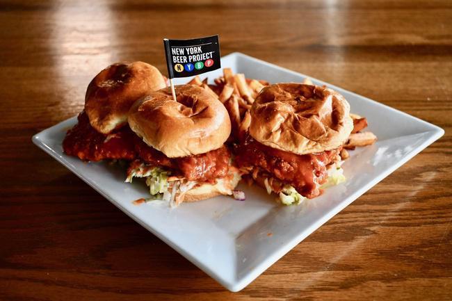 Nashville Hot Chicken Sliders · SPICY fried chicken sliders, coated in the music city's famous brown sugar, butter, and cayenne hot sauce! Topped with Nashville slaw and sweet pickles.