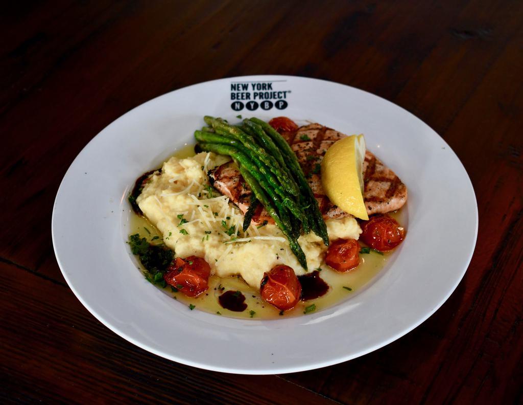 South Street Salmon · Fresh Atlantic salmon grilled to perfection and served over creamy polenta with parmesan cheese, blistered tomatoes and EVOO reduction. Topped with grilled asparagus and a balsamic drizzle.