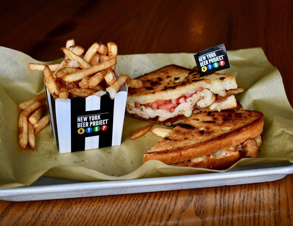 Love Child Panini · Fall in love with this delicious panini piled high with thinly sliced turkey, Swiss cheese, crispy bacon,
tomatoes, and our amazing secret sauce. Served with fresh cut fries.