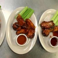 Chicken Wings · Cooked wing of a chicken coated in sauce or seasoning.