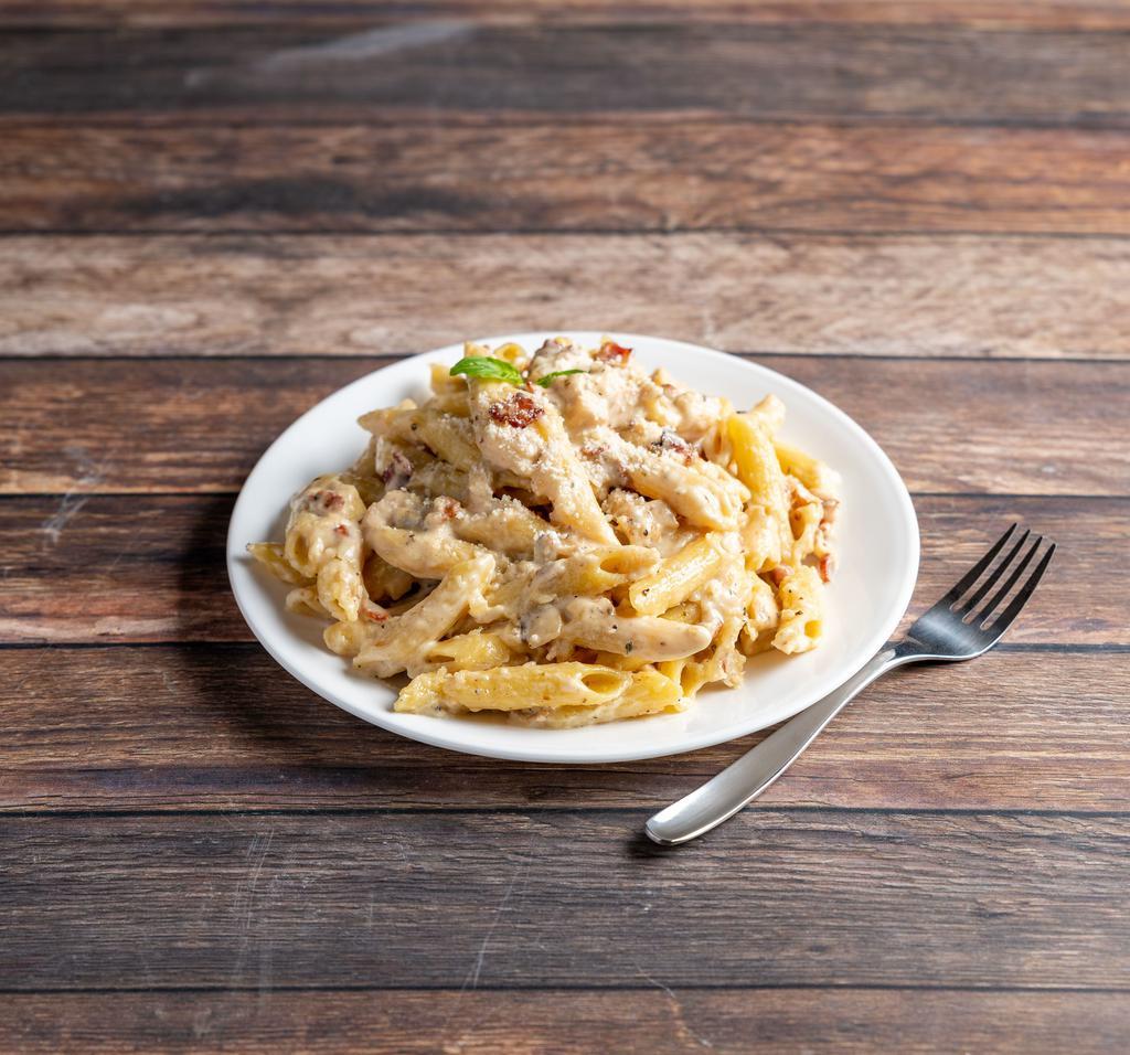 Penne Chicken Alfredo · Grilled chicken, bacon, onion, garlic and cracked black pepper in a Parmesan Alfredo sauce tossed with penne pasta.