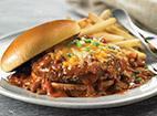 Knife & Fork Chili Burger · A delicious beef patty smothered in our famous chili. Topped with aged cheddar and jack cheese and green onions on a toasted bun.