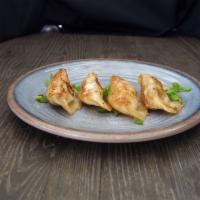 Pot Stickers · 4 hand-made dumplings stuffed with pork, cabbage, garlic, ginger and scallions. Served with ...