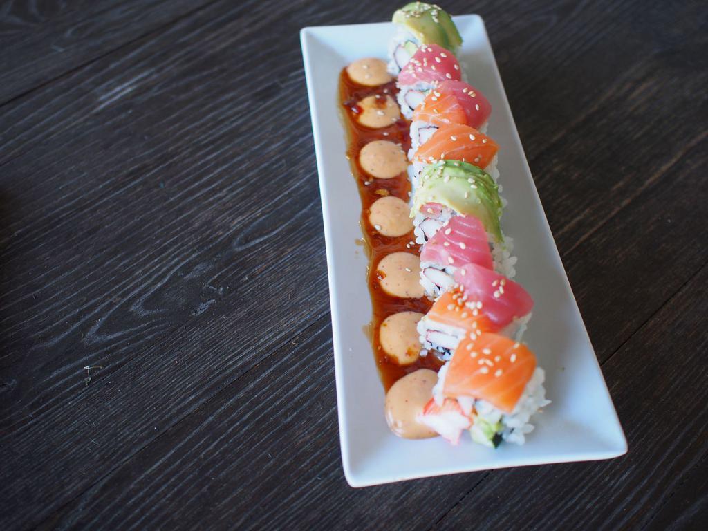 Rainbow Roll · 8 pieces. Krab, avocado, cucumber, sesame seeds, topped with avocado, salmon, tuna, dressed with spicy mayo and caramel glaze. Rolled to order, up to 10 minutes.