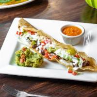 Machete · Long folded tortilla stuffed with meat of choice, lettuce, tomato, queso fresco, and sour cr...