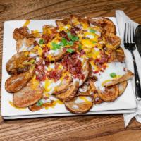 Loaded Broasted Potatoes · 1 lb. of broasted potatoes topped with melted cheddar cheese, bacon bits, chives, seasoned s...