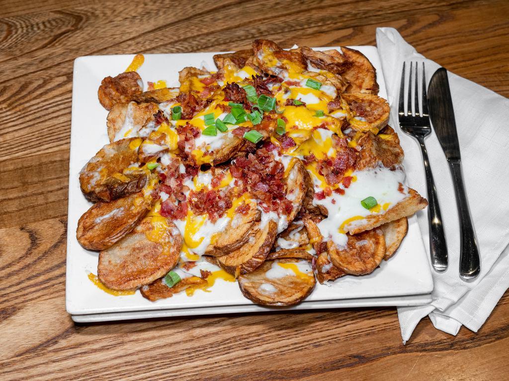 Loaded Broasted Potatoes · 1 lb. of broasted potatoes topped with melted cheddar cheese, bacon bits, chives, seasoned sour cream. Additional salsa or sour cream
for an additional charge. Gluten free.