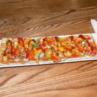 Thai Chicken Flatbread · Thai peanut sauce, crispy chicken, red onion, red peppers, cheddar. Topped with Sriracha and...