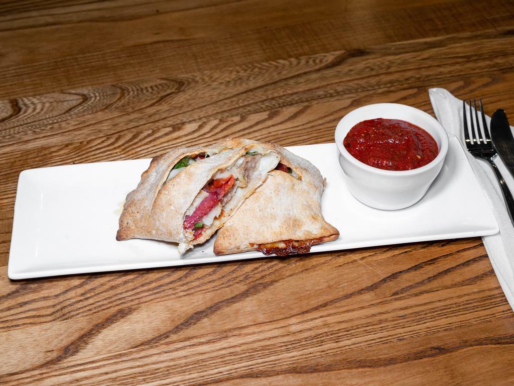 The Big Italian Stromboli · Spicy Italian sausage, pepperoni, capicola, salami, onions, green peppers, mozzarella cheese. Served with a side of pizza sauce.