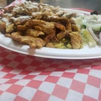 Chicken Gyro Salad · Salad with thin slices of roasted meat.