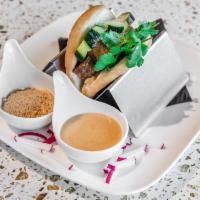 Bao Slider · 1 piece. Fried Asian bun filled with choice of protein, pickled cucumbers, and cilantro. Ser...