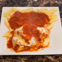 Chicken Parmigiana · Homemade marinara sauce over tender chicken cutlet smothered in mozzarella and grated Parmes...