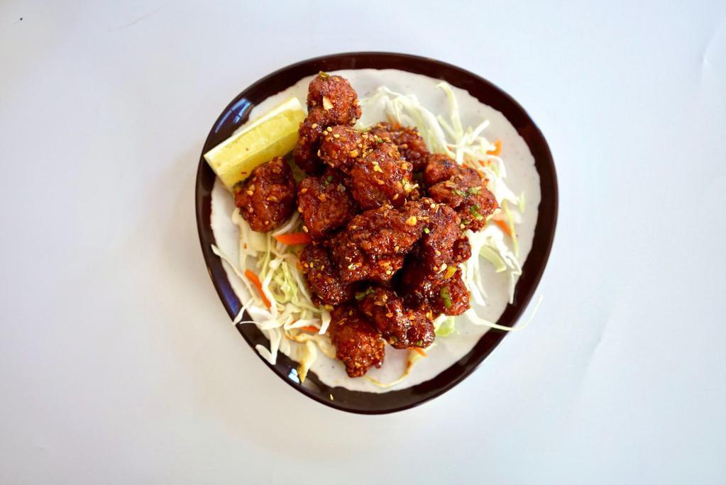 Gochujang Popcorn Chicken  · Bite Sized Pieces of Chicken Sautéed with Gochujang Sauce, topped with Crispy Garlic, Green Onions and Toasted Sesame Seeds