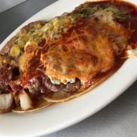 Burger Ranchero · 2 corn tortillas topped with a ground beef patty and 2 eggs, smothered with red or green chi...