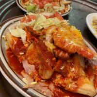 Breakfast Sopapilla · 2 scrambled eggs and potatoes stuffed in a sopapilla and smothered with chile and cheese wit...