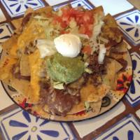 Nachos Grande · Beans, cheese, guacamole, sour cream, salsa and jalapenos. Add ground beef or chicken for an...