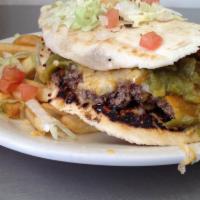 Torta Burger · Homemade flour tortilla folded with a ground beef patty, smothered with red or green chile, ...