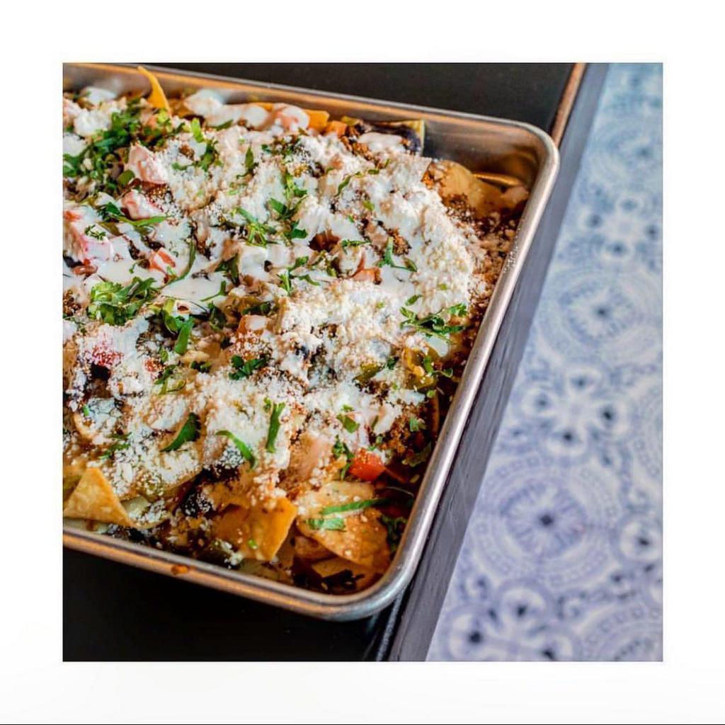 Nachos · corn chips, black beans, queso, cilantro, tomatoes, onions, crema, jalapeños, cotija cheese

Add Beef, Chicken or Carnitas... +3