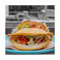 Carnitas Taco  · Rich and tender carnitas in a puffy shell with cheese, lettuce, & tomato