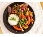 Pollo Saltado · Chicken with onions and tomatoes served over french fries and rice.