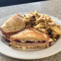 Marco’s Turkey Reuben  · Thin sliced turkey breast, swiss cheese, apple cabbage compote, 1000 island on sourdough bre...