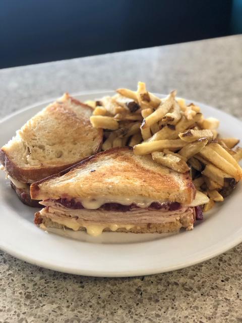 Marco’s Turkey Reuben  · Thin sliced turkey breast, swiss cheese, apple cabbage compote, 1000 island on sourdough bread & your choice of side.


