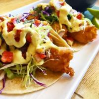 Baja Fish Tacos · Two pacific cod tempura beer battered tacos, cabbage, white sauce, fire roasted red salsa, a...